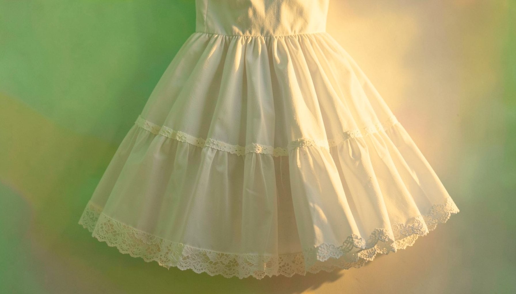 A layered white petticoat with lace trim, photographed in soft diffused light against a pastel backdrop.